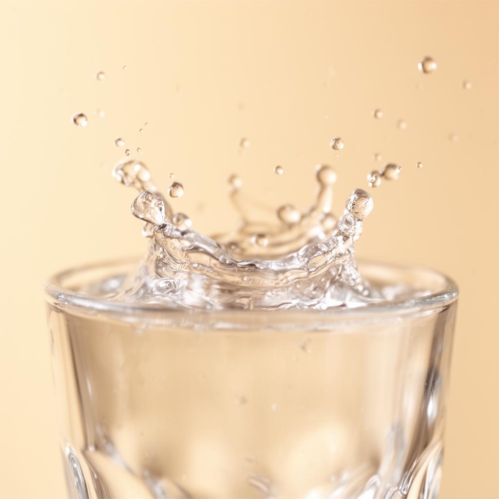 Clean water splashing in a glass